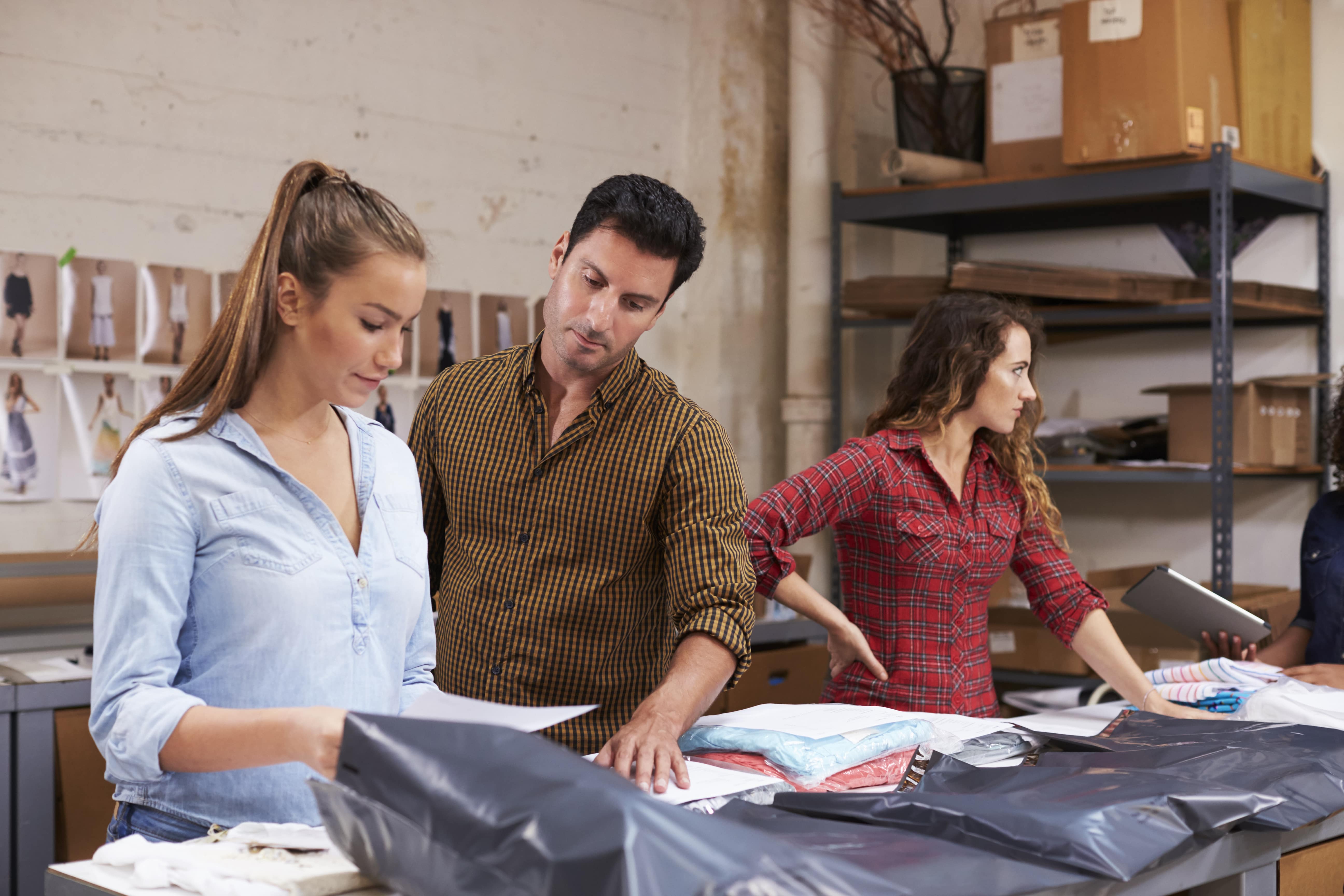male-manager-with-trainee-packing-orders-for-distr-2021-08-26-16-13-06-utc